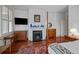Bedroom featuring a decorative fireplace, hardwood floors, and side tables at 41 Legare St # C, Charleston, SC 29401