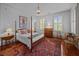 Bedroom with 4-poster bed, Persian rug, and bright natural light at 41 Legare St # C, Charleston, SC 29401