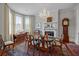 Elegant dining room with ample natural light, a fireplace, hardwood floors, and seating for six at 41 Legare St # C, Charleston, SC 29401