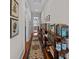Charming hallway with wood floors, a decorative rug, and built-in bookshelves displaying literary collections at 41 Legare St # C, Charleston, SC 29401