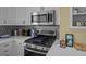 Close-up of a kitchen with stainless steel microwave and decorative backsplash at 41 Legare St # C, Charleston, SC 29401