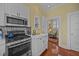 View of a kitchen with stainless steel appliances and a doorway leading to another room at 41 Legare St # C, Charleston, SC 29401
