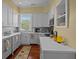 Well-lit kitchen featuring white cabinets, modern appliances, and a window view at 41 Legare St # C, Charleston, SC 29401