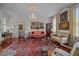 Elegant living room with beautiful rug, chandelier, artwork, and plenty of comfortable seating at 41 Legare St # C, Charleston, SC 29401