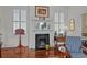 Cozy living room features a fireplace with decorative mantle, hardwood floors, and natural light at 41 Legare St # C, Charleston, SC 29401