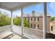 Spacious porch offers lounge chairs and views of historic buildings and lush greenery at 41 Legare St # C, Charleston, SC 29401