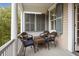 Charming outdoor porch with wicker seating, perfect for relaxing and enjoying the neighborhood views at 41 Legare St # C, Charleston, SC 29401