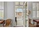 Inviting porch view from inside the home with bright, natural light and charming wicker furniture at 41 Legare St # C, Charleston, SC 29401