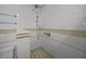 Shower with chrome shower head and coordinating tiled walls at 41 Legare St # C, Charleston, SC 29401