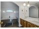 Elegant bathroom features double vanities, modern lighting fixtures, and a soaking tub with a tiled surround at 413 Station 22 1/2 St, Sullivans Island, SC 29482