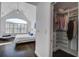 Light-filled bedroom features vaulted ceilings, a ceiling fan, and a walk-in closet with custom shelving at 413 Station 22 1/2 St, Sullivans Island, SC 29482