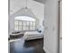 Bright bedroom boasts vaulted ceilings, a ceiling fan, and a large window with plantation shutters at 413 Station 22 1/2 St, Sullivans Island, SC 29482