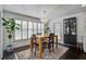 Bright dining area with wood table, stylish chandelier, and neutral rug at 413 Station 22 1/2 St, Sullivans Island, SC 29482