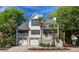 Charming two-story home featuring double garages and palm trees in a desirable location at 413 Station 22 1/2 St, Sullivans Island, SC 29482