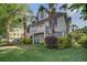 Charming coastal home with lush landscaping, palm trees, and a welcoming porch at 413 Station 22 1/2 St, Sullivans Island, SC 29482