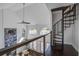 View of the living area with dark hardwood floors and access to a spiral staircase at 413 Station 22 1/2 St, Sullivans Island, SC 29482