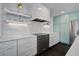 Contemporary kitchen features marble countertops, stainless steel appliances, and stylish cabinetry at 413 Station 22 1/2 St, Sullivans Island, SC 29482