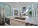 View of the Kitchen Island showing its marble countertops and connection to the living room at 413 Station 22 1/2 St, Sullivans Island, SC 29482