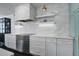 Contemporary kitchen features marble countertops, stainless steel appliances, and stylish cabinetry at 413 Station 22 1/2 St, Sullivans Island, SC 29482