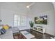 Comfortable living room featuring a sectional sofa, flat-screen TV, and plantation shutters at 413 Station 22 1/2 St, Sullivans Island, SC 29482