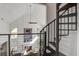 Open-concept living area features vaulted ceilings, a fireplace, and unique spiral staircase at 413 Station 22 1/2 St, Sullivans Island, SC 29482
