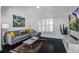 Comfortable living room featuring a sectional sofa, flat-screen TV, and plantation shutters at 413 Station 22 1/2 St, Sullivans Island, SC 29482