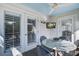 Inviting covered patio features a ceiling fan, a TV and a cozy dining set at 413 Station 22 1/2 St, Sullivans Island, SC 29482