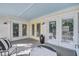 Charming porch with double doors and comfortable seating area, great for enjoying the outdoors at 413 Station 22 1/2 St, Sullivans Island, SC 29482