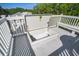 Rooftop deck with a unique stairwell access and white wooden railing at 413 Station 22 1/2 St, Sullivans Island, SC 29482