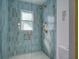 Stylish walk-in shower featuring blue tile, bronze fixtures, and a glass surround at 413 Station 22 1/2 St, Sullivans Island, SC 29482