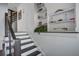 Staircase with dark wood handrail and trim, and built-in display shelves at 413 Station 22 1/2 St, Sullivans Island, SC 29482