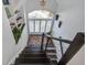 Well-lit staircase with dark hardwood steps, white walls, and a decorative rug at 413 Station 22 1/2 St, Sullivans Island, SC 29482