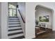 Bright staircase with hardwood steps leads to a living room with hardwood floors at 413 Station 22 1/2 St, Sullivans Island, SC 29482