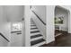 Elegant staircase with dark wood treads and white risers leading to the upper level at 413 Station 22 1/2 St, Sullivans Island, SC 29482