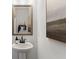 Stylish powder room with a pedestal sink, elegant mirror, and sophisticated decor at 4314 Grange Cir, Summerville, SC 29486