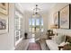 Bright foyer with hardwood floors, transom windows, modern light fixture, and a glimpse of the outdoors at 4314 Grange Cir, Summerville, SC 29486