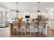 Stylish kitchen with hardwood floors, an island with barstools, white cabinets, and stainless steel appliances at 4314 Grange Cir, Summerville, SC 29486