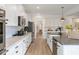 Bright kitchen features stainless appliances, white cabinetry, and hardwood floors, with an island sink at 4314 Grange Cir, Summerville, SC 29486