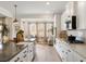 Well-lit kitchen showcases white cabinets, stainless appliances, hardwood floors and adjacent sitting room at 4314 Grange Cir, Summerville, SC 29486