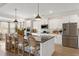 Bright, open kitchen featuring a spacious island with seating, stainless steel appliances and white cabinetry at 4314 Grange Cir, Summerville, SC 29486