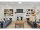 Bright living room boasts built-in bookshelves, cozy seating and a marble fireplace at 4314 Grange Cir, Summerville, SC 29486