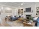 Inviting living room with built-in bookshelves, fireplace, coffered ceiling, and stylish furnishings at 4314 Grange Cir, Summerville, SC 29486