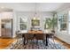 Bright dining area with hardwood floors, natural light, a unique table, and modern decor at 4524 Orr St, North Charleston, SC 29405