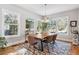 Elegant dining room boasts hardwood floors, modern lighting, a large table, and bright natural light at 4524 Orr St, North Charleston, SC 29405