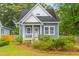 Inviting home exterior featuring a quaint front porch, manicured landscaping, and classic architectural details at 4524 Orr St, North Charleston, SC 29405