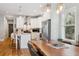 Stylish kitchen with white cabinets, stainless steel appliances, a large island, and modern lighting at 4524 Orr St, North Charleston, SC 29405