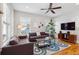 Bright living room features hardwood floors, neutral walls, stylish furniture, and ample natural light from windows at 4524 Orr St, North Charleston, SC 29405