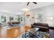 Open-concept living space with hardwood floors, natural light, modern furnishings, and a dining area at 4524 Orr St, North Charleston, SC 29405