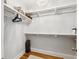 Spacious walk-in closet with shelving, hanging rods, hardwood floors, and decorative light fixture at 4524 Orr St, North Charleston, SC 29405