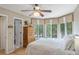 Comfortable bedroom with bay windows, neutral colors, and wood accents at 4856 Green Dolphin Way # Share 7, Kiawah Island, SC 29455